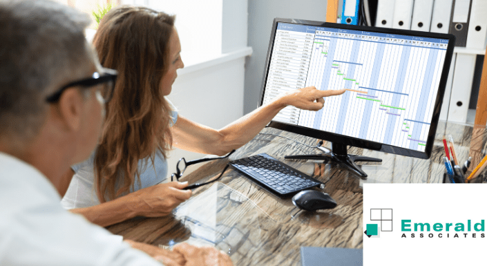 Two senior project managers analyse a Gantt chart