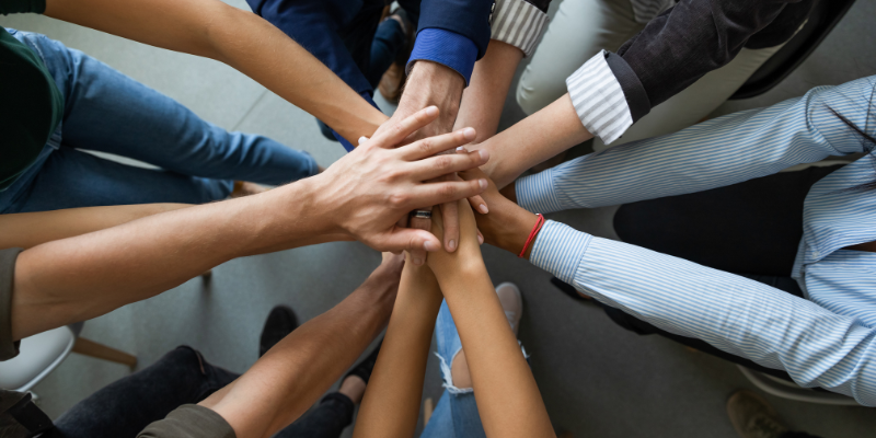 All Team's Hands in the Centre